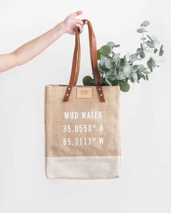 Mud Water Wine Tote filled with a spray of eucalyptus