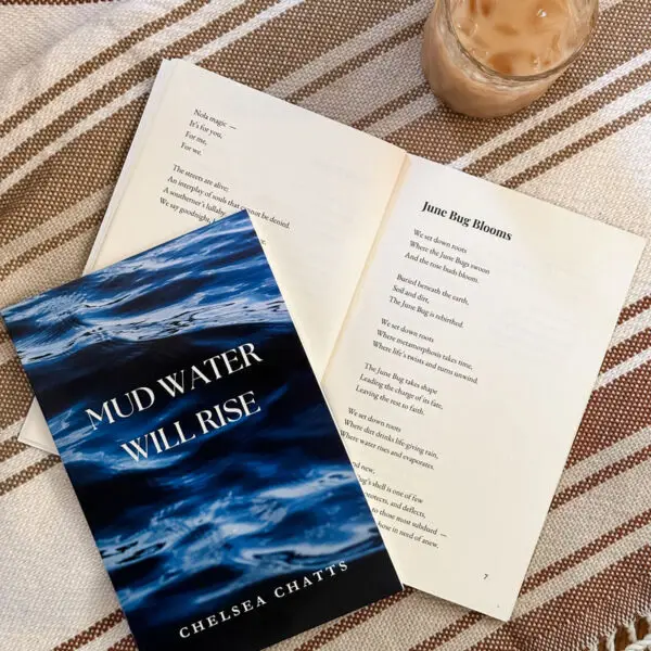 Mud Water Will Rise Poetry Book with a cup of iced coffee